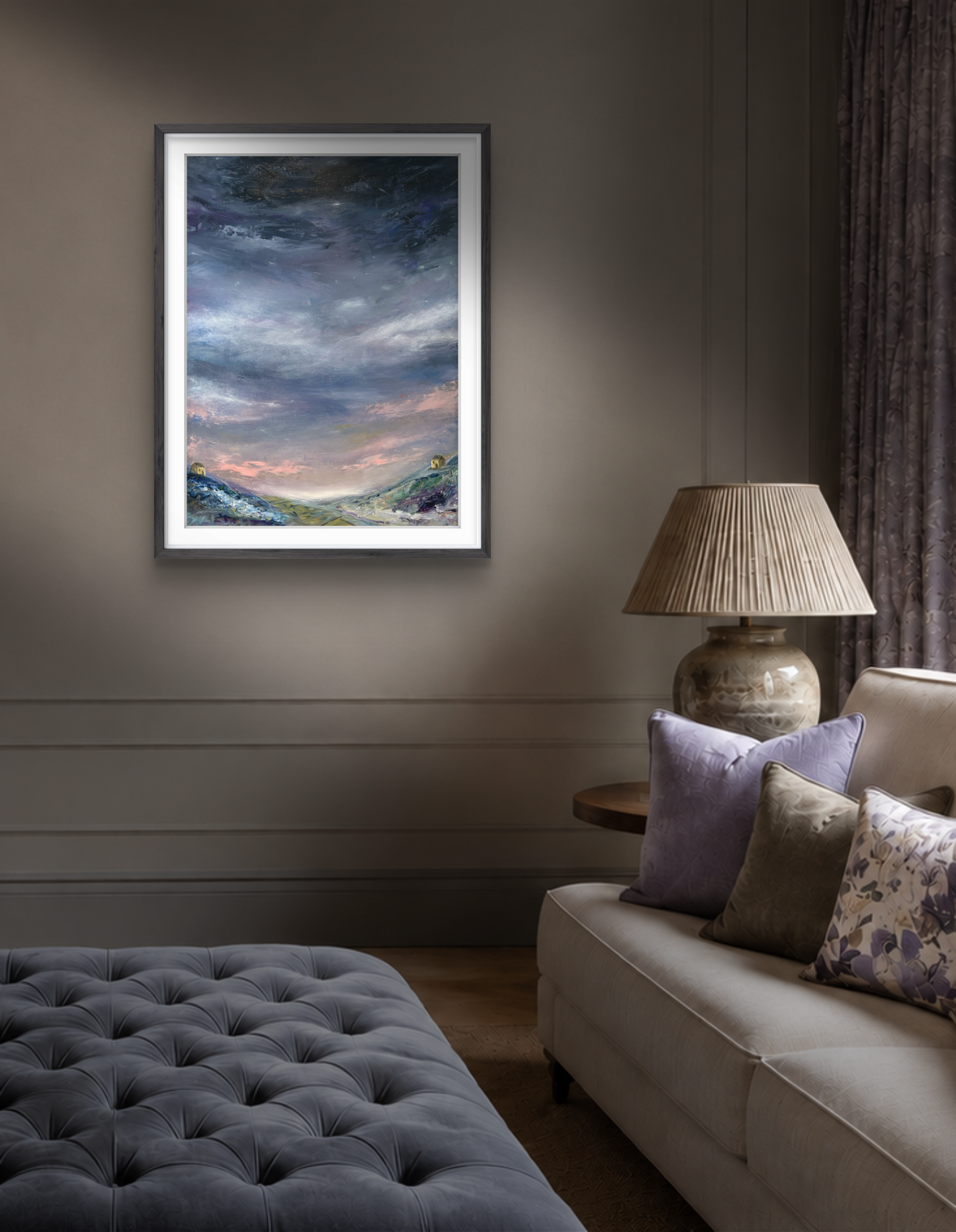 Framed moorland landscape print on a wall above a sofa in a living room.