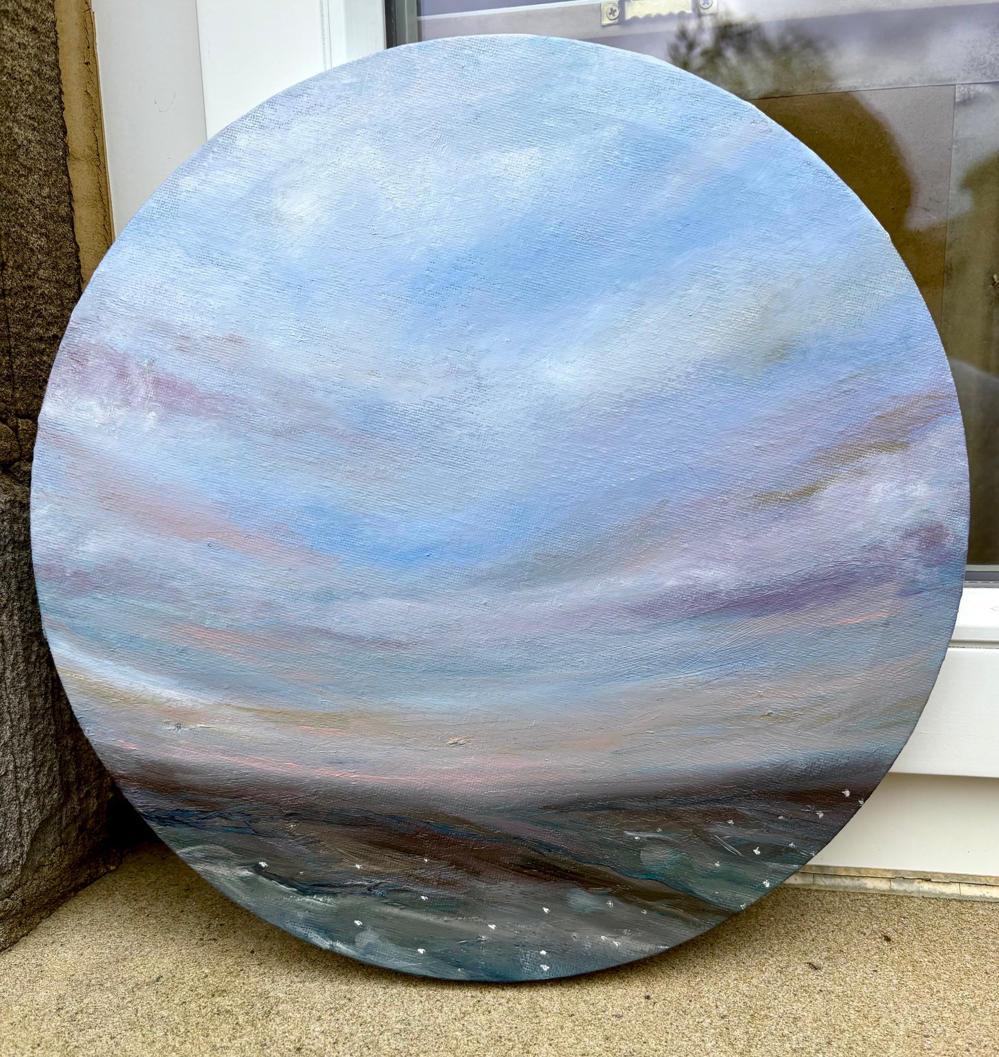 circular oil painting featuring expressive blue and purple sky against a moorland view