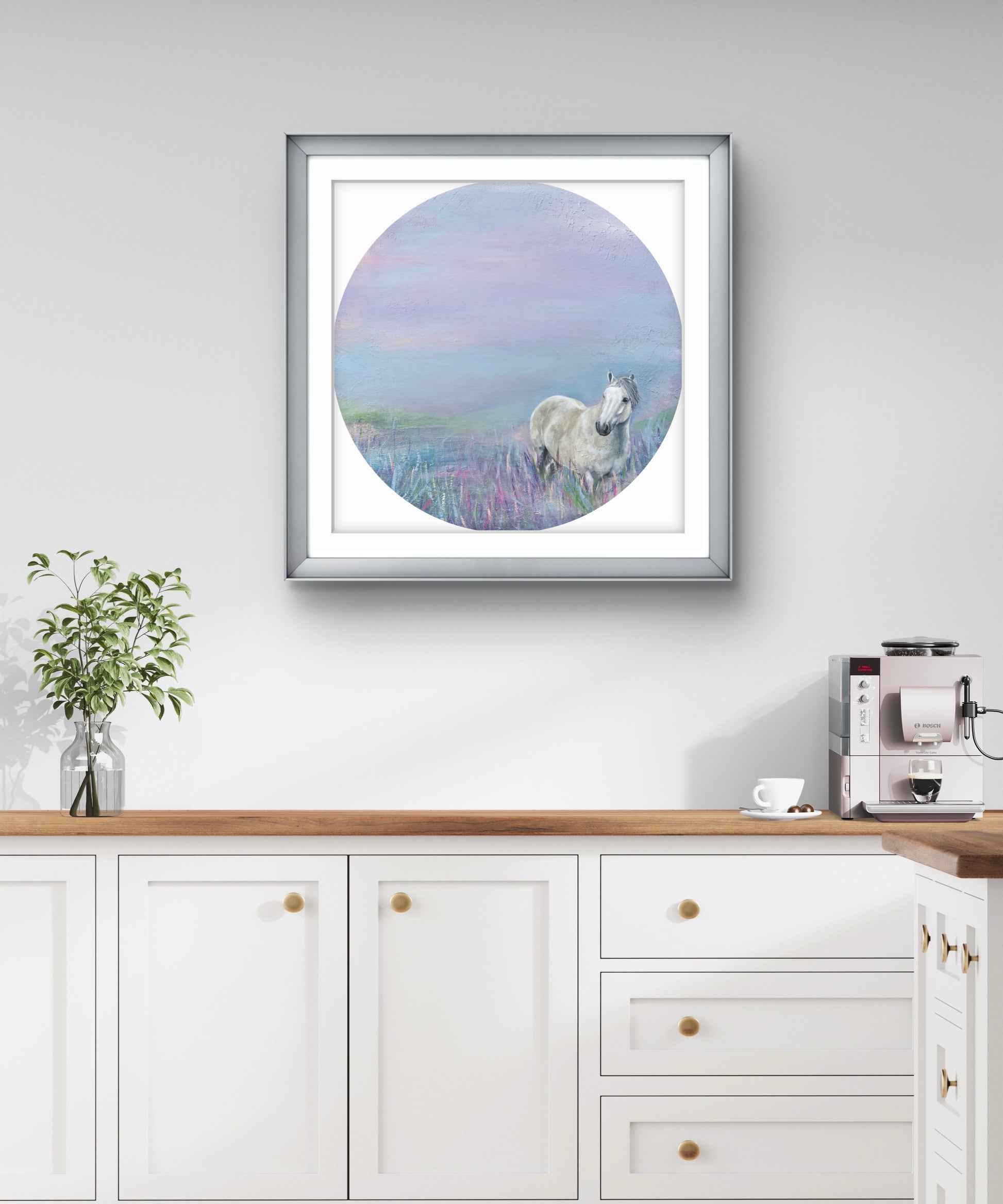 Framed artwork of a horse in a lavender field on a wall above a kitchen counter.