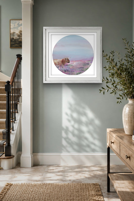 Framed artwork of a lavender field with a cow on a wall in a home setting.