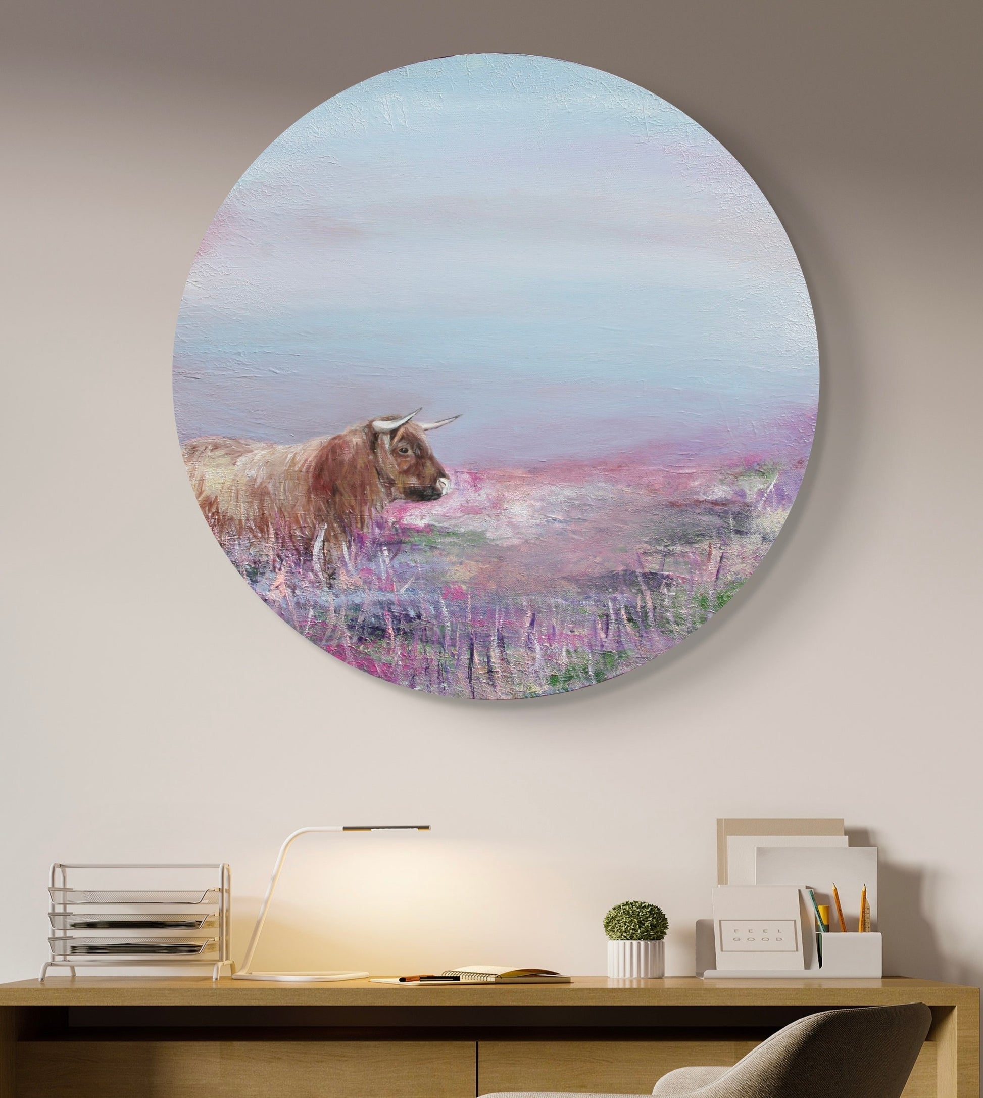 Highland cow painting on a circular canvas above a sideboard