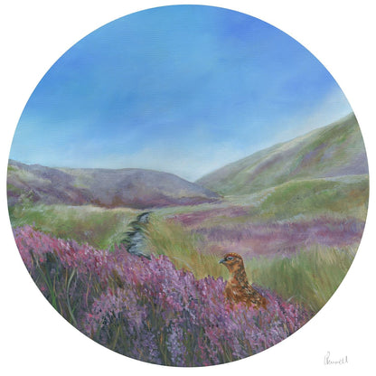 A circular landscape fine art print featuring a red grouse perched on a field of purple heather, with rolling green and purple hills under a blue sky in the background.