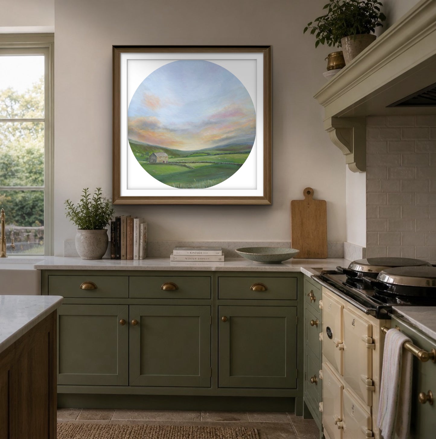Kitchen interior with green cabinets, a stove, and a framed countryside landscape painting on the wall.