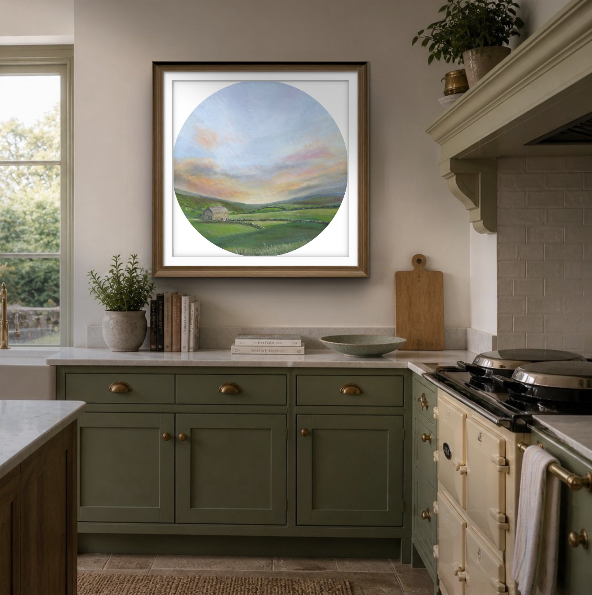 Kitchen interior with green cabinets, a stove, and a framed countryside landscape painting on the wall.