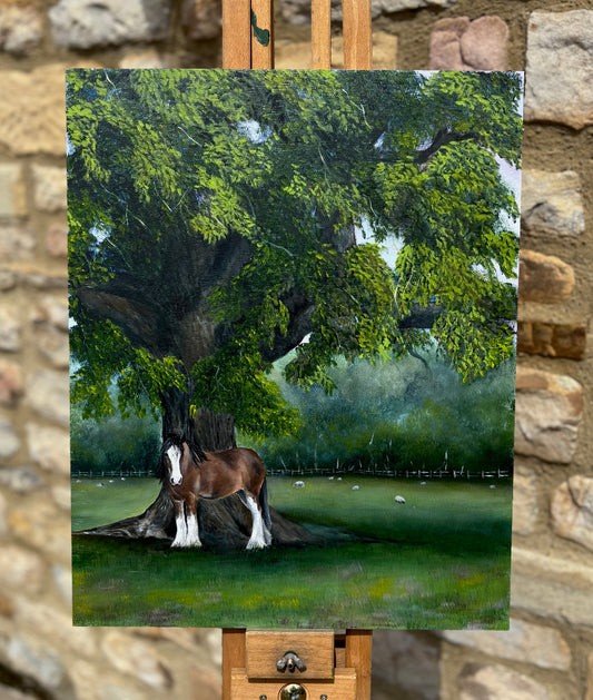 Painting of a horse under a tree on an easel against a stone wall background