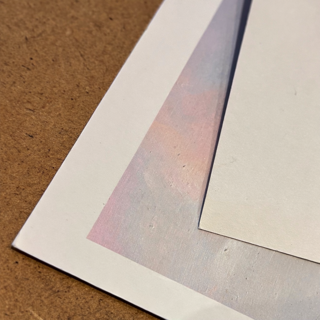 Close-up of textured paper sheets on a brown surface