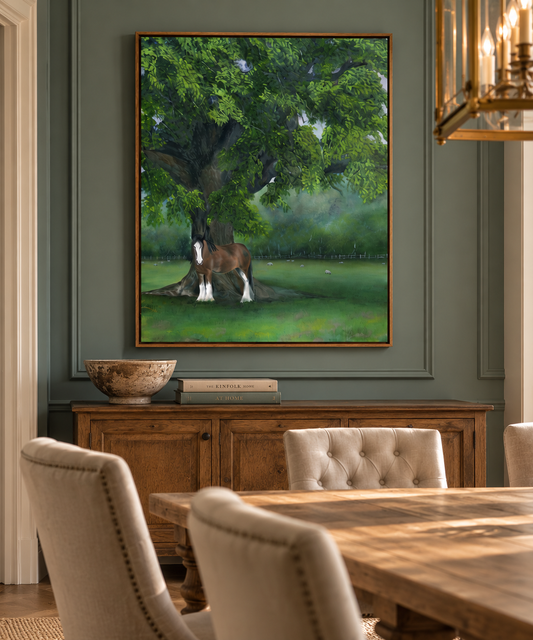 A framed painting of a brown and white horse standing under a large green tree, displayed on a dark gray wall in a dining room setting above a wooden sideboard.